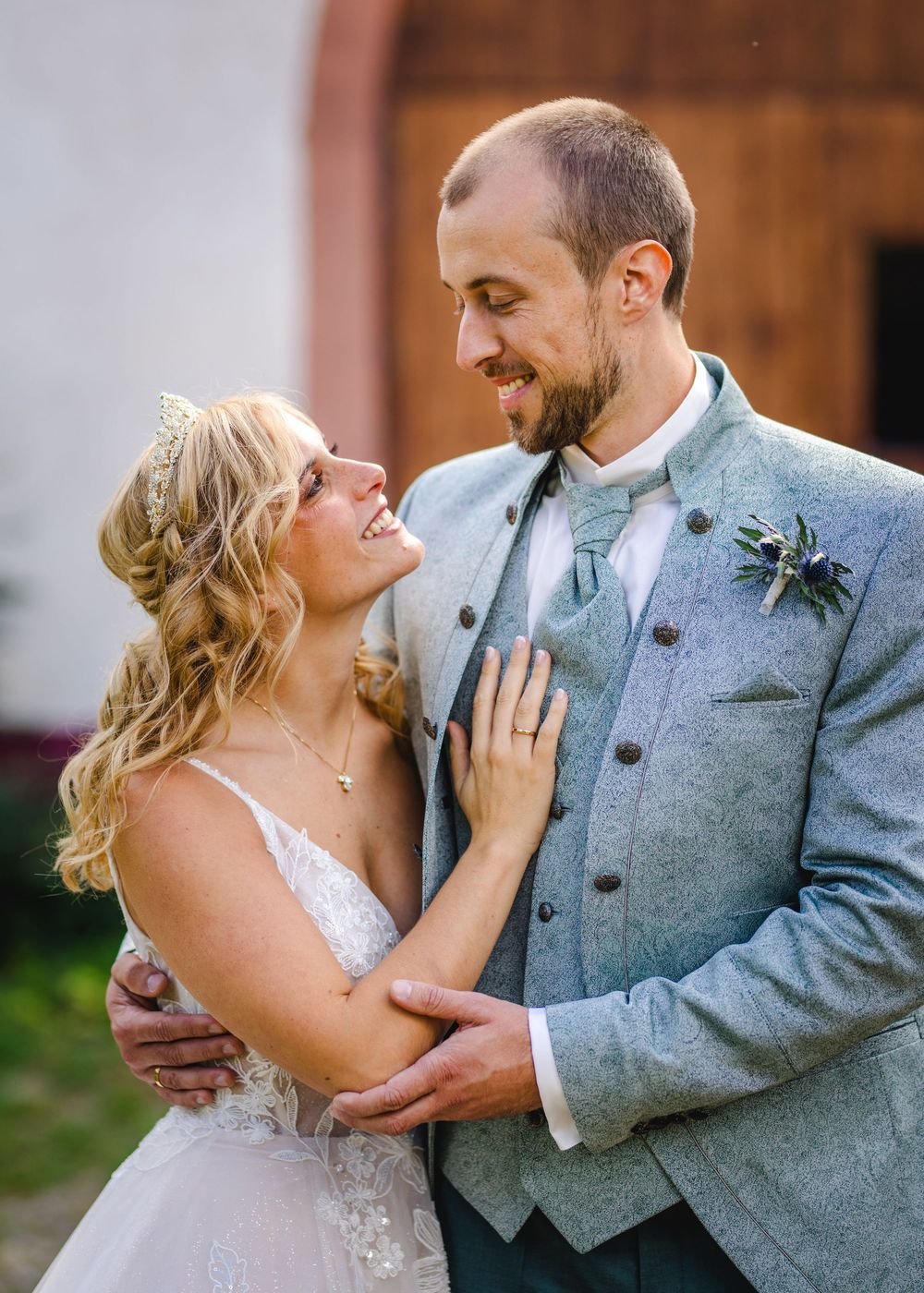 A couple in wedding attire share intimate moments in a series of romantic photos against a rustic backdrop.
