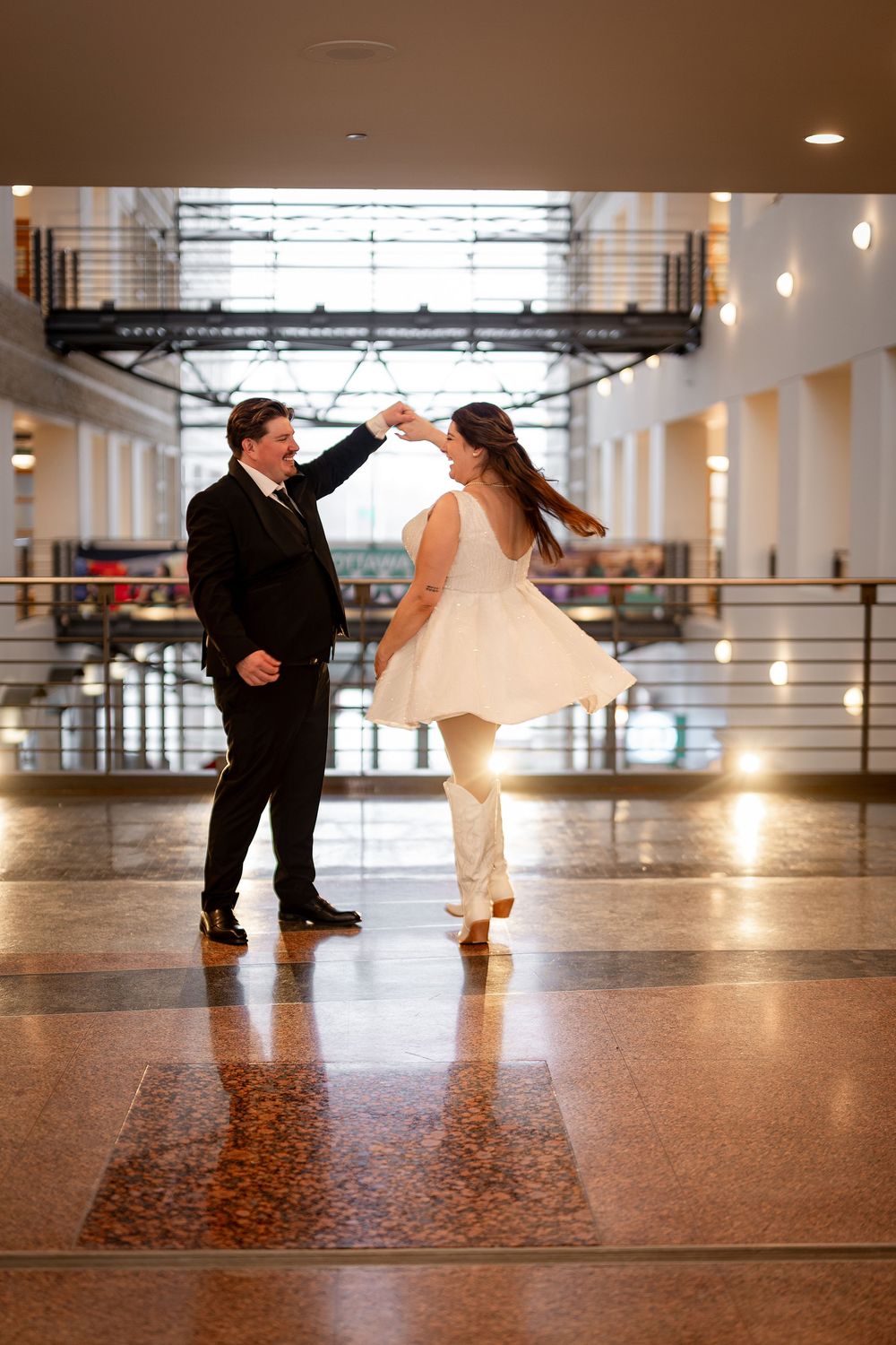 A creative low-angle dance sequence showing spinning movements on a polished floor.