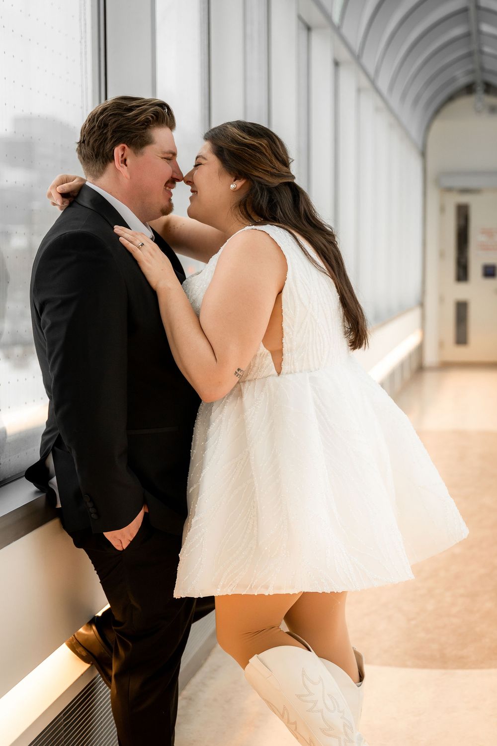 A romantic sequence under an arched colonnade with natural lighting and architectural details.