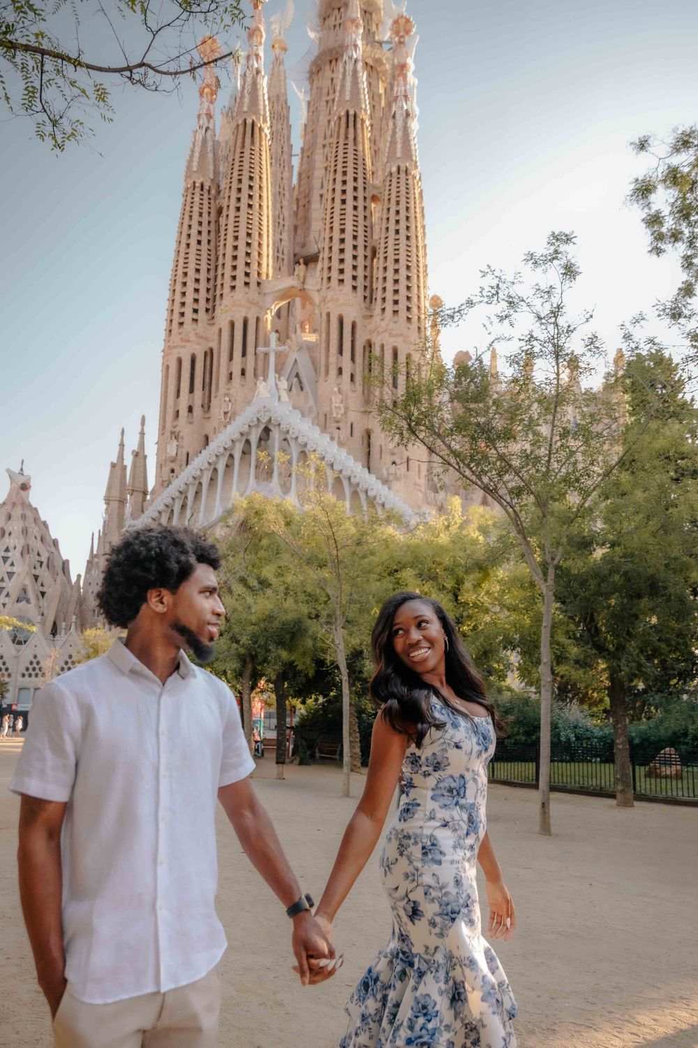 Geometric lines of Gaudí architecture framing a stylish couple.