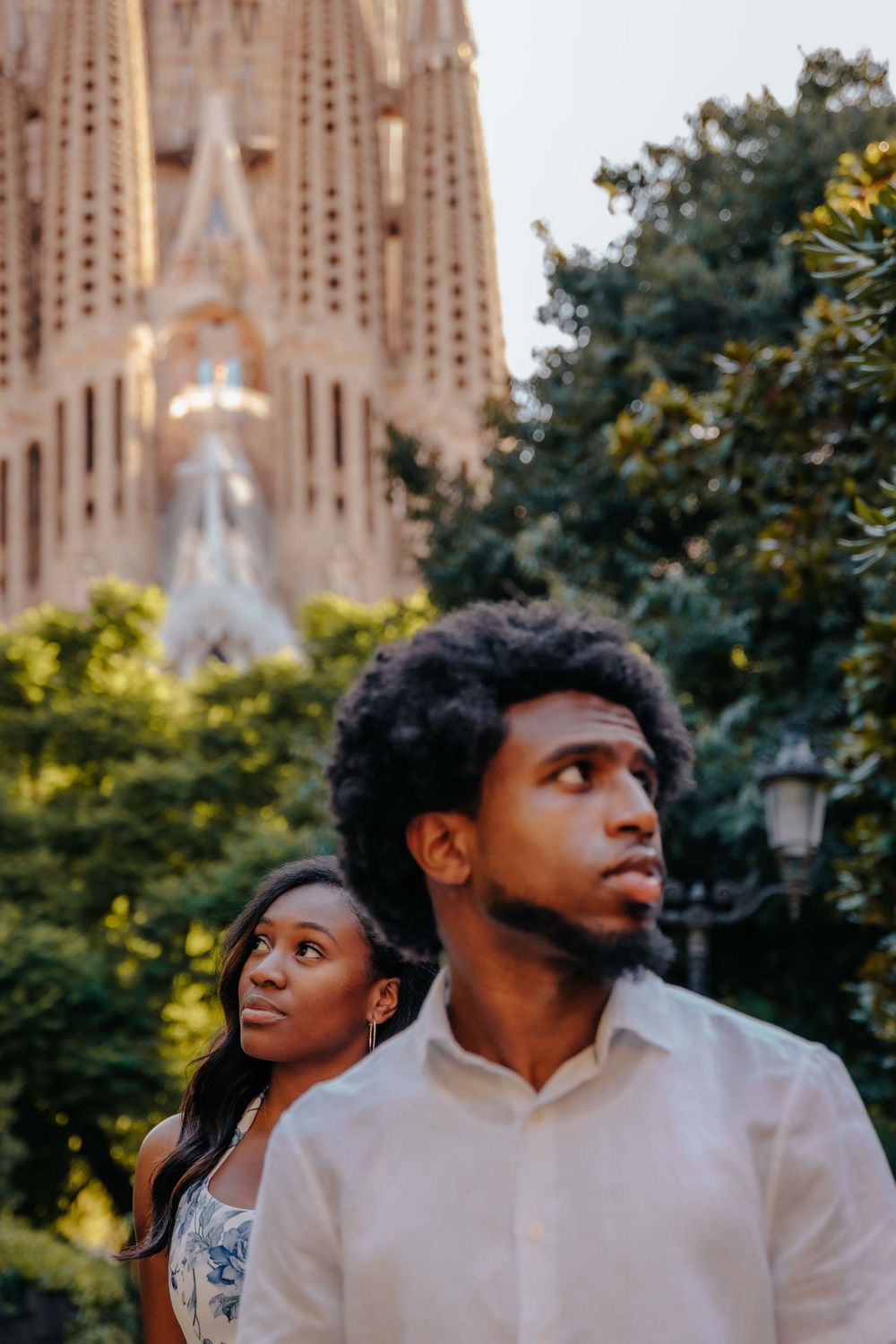 Nadia and Quon walking near Sagrada Familia passion facade August mor