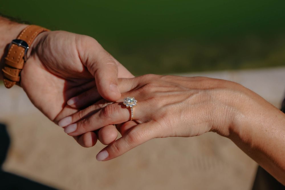 Mieke admiring her new ring with look of shock and joy.