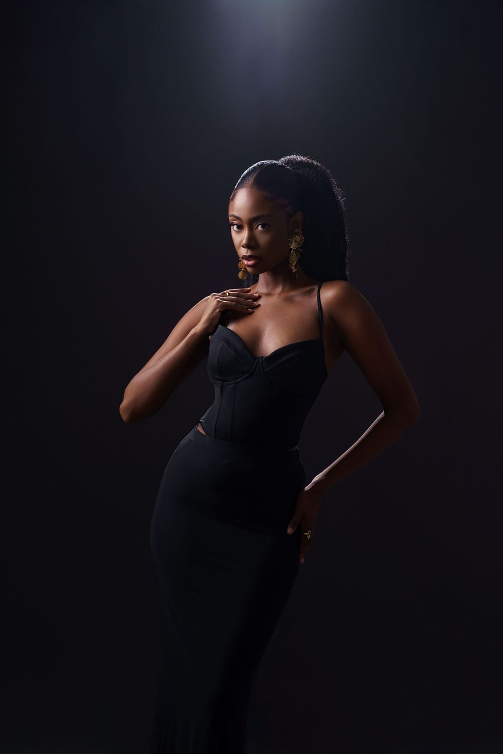 Dramatic portrait series showing a figure in black against dark background with moody artistic lighting.