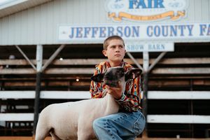 Fairgrounds entrance with blue and white signage displaying Jefferson County Fair text visible in daylight.