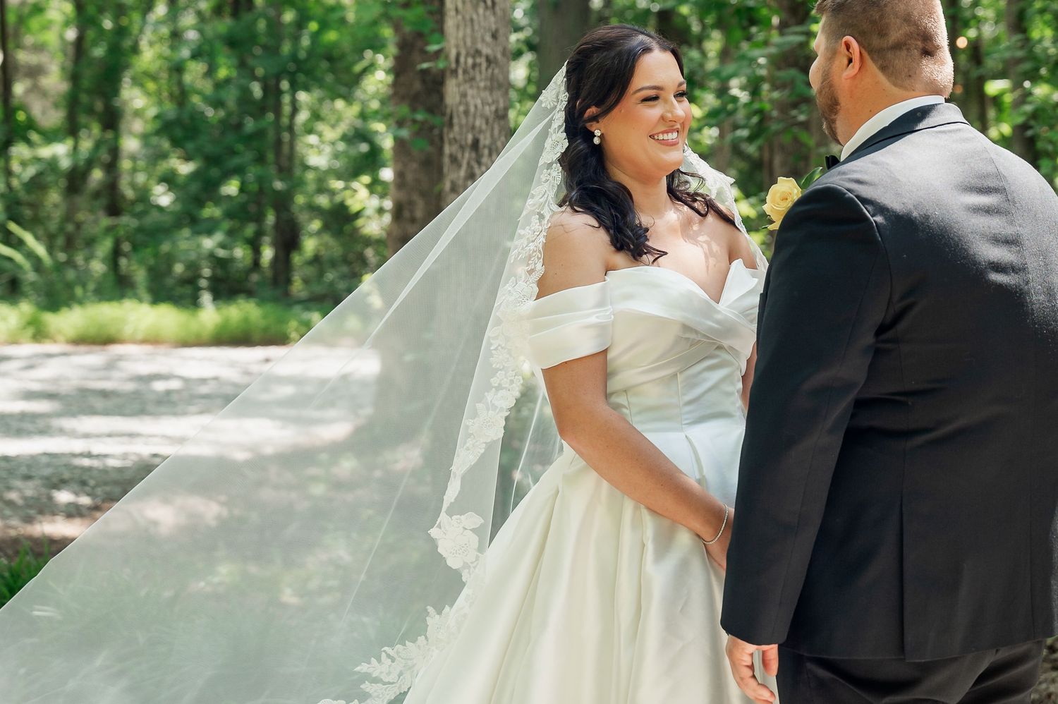 An outdoor wedding first look moment captured in a series of romantic photographs.