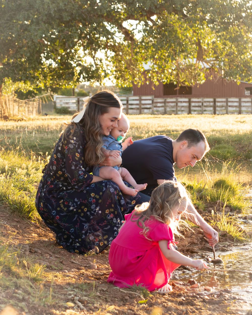 Children exploring and playing in a sun-drenched meadow during golden hour.