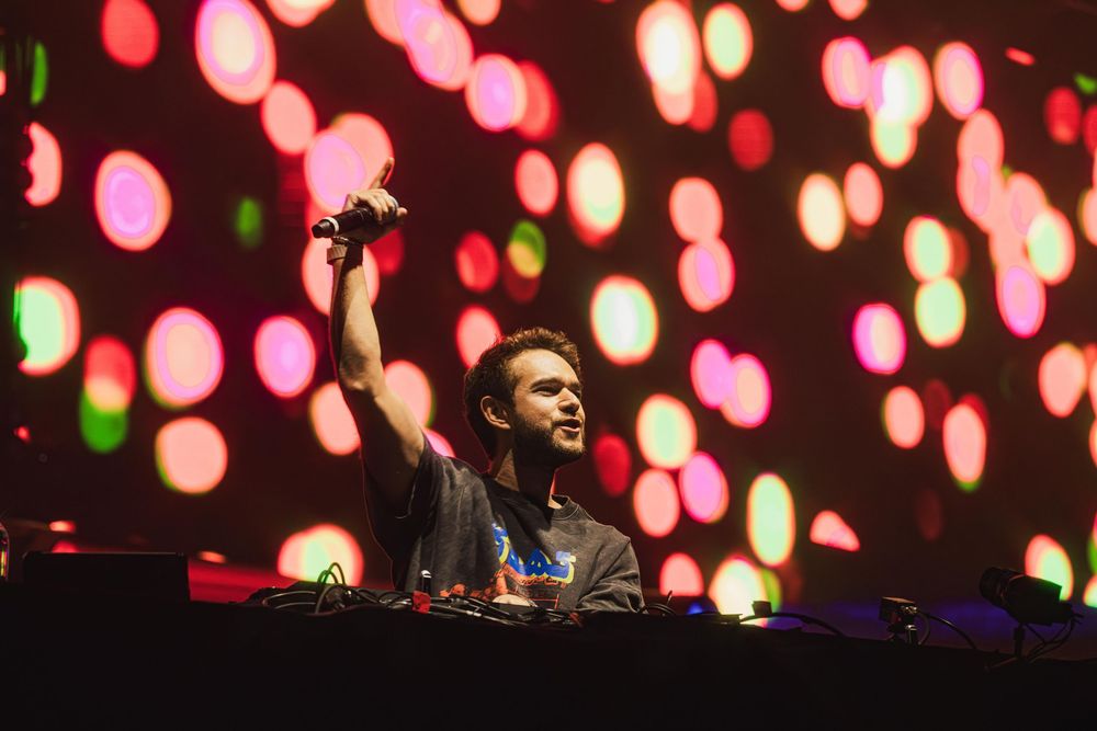 Concert stage illuminated with pink and red bokeh lights creating dreamy atmosphere.
