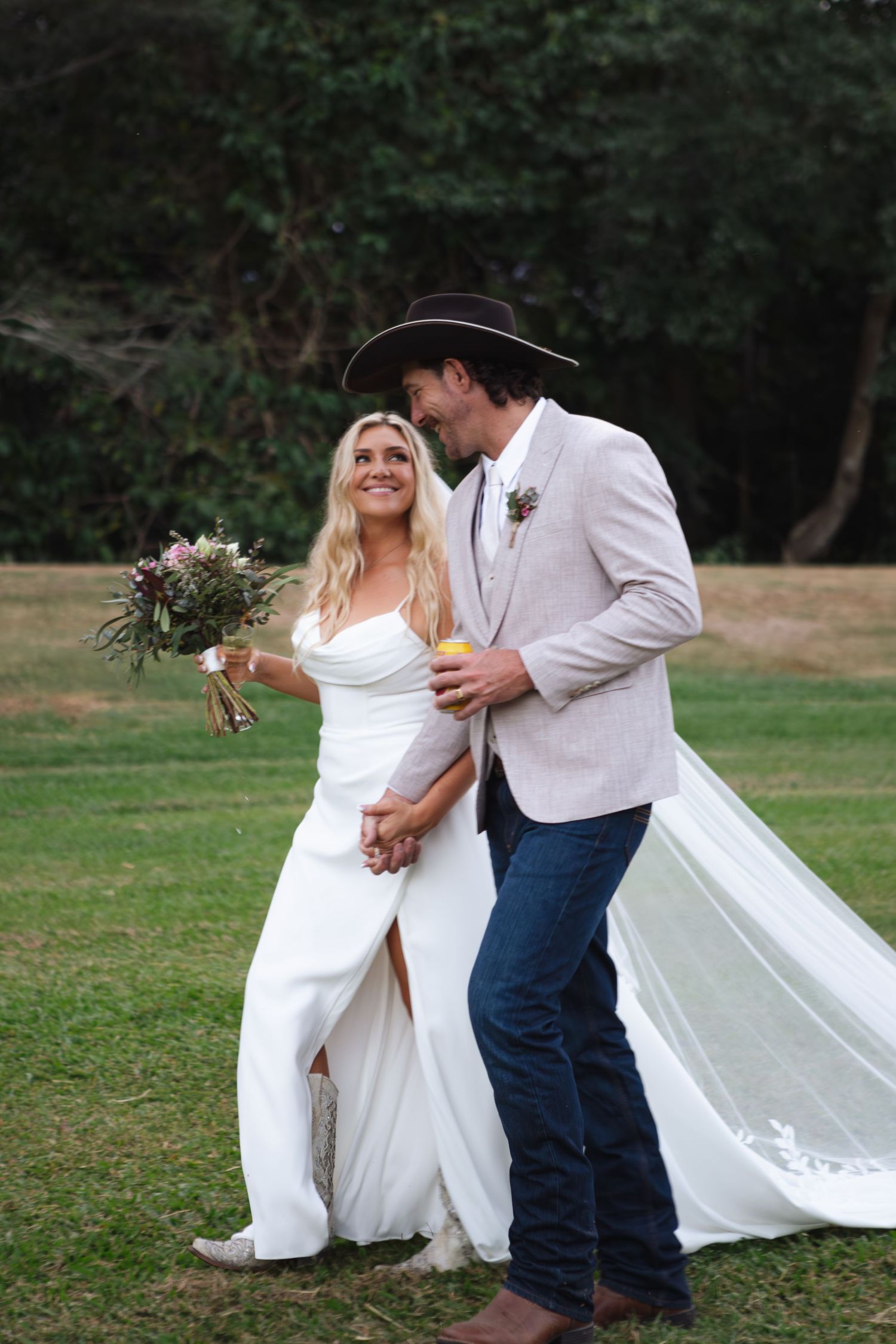 Bride and groom walking hand in hand smiling at country Port Douglas Wedding