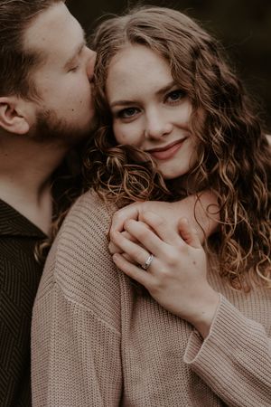 Intimate black and white portrait of couple sharing tender moment.