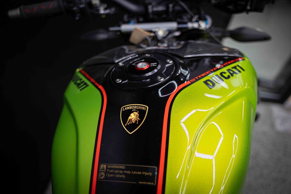 Neon green Lamborghini motorcycle fuel tank with racing number graphics.