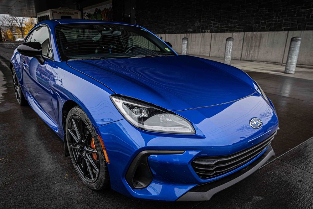 Series of exterior shots showing a bright blue sports car from different angles.
