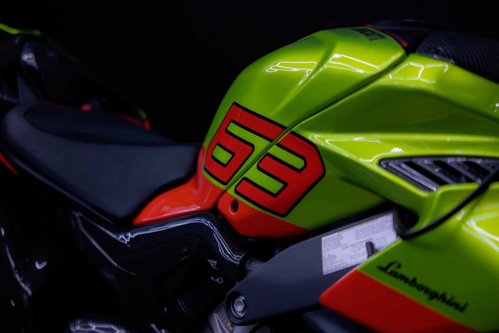 Bright green Lamborghini motorcycle tank with red racing number 53.