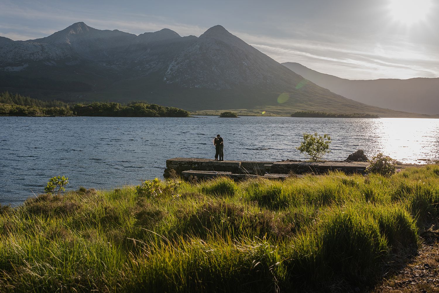 Adventure elopement couple embracing beside a lake in Connemara
