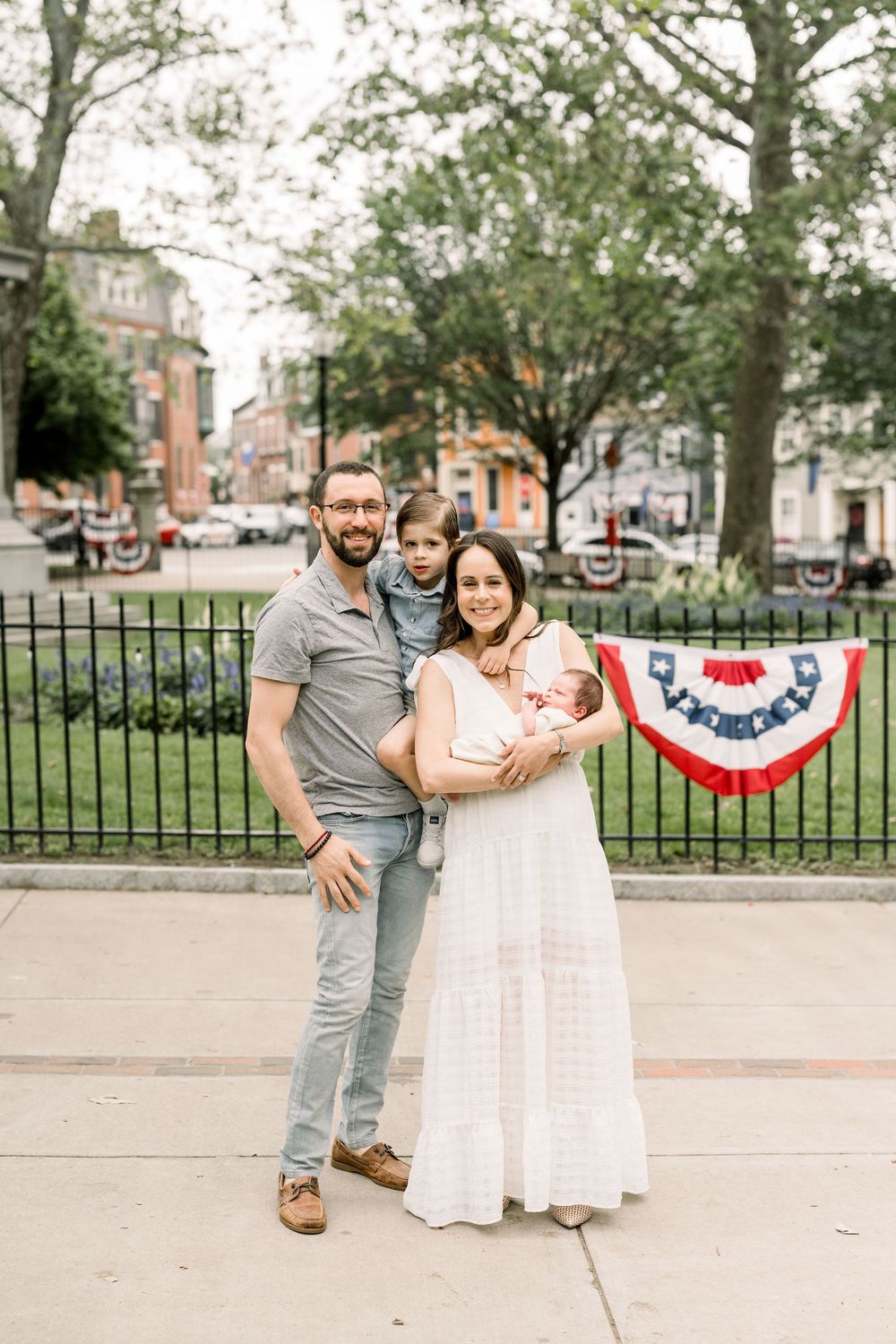 A series of candid outdoor photos showing joyful moments in a park setting with American patriotic bunting decorations.