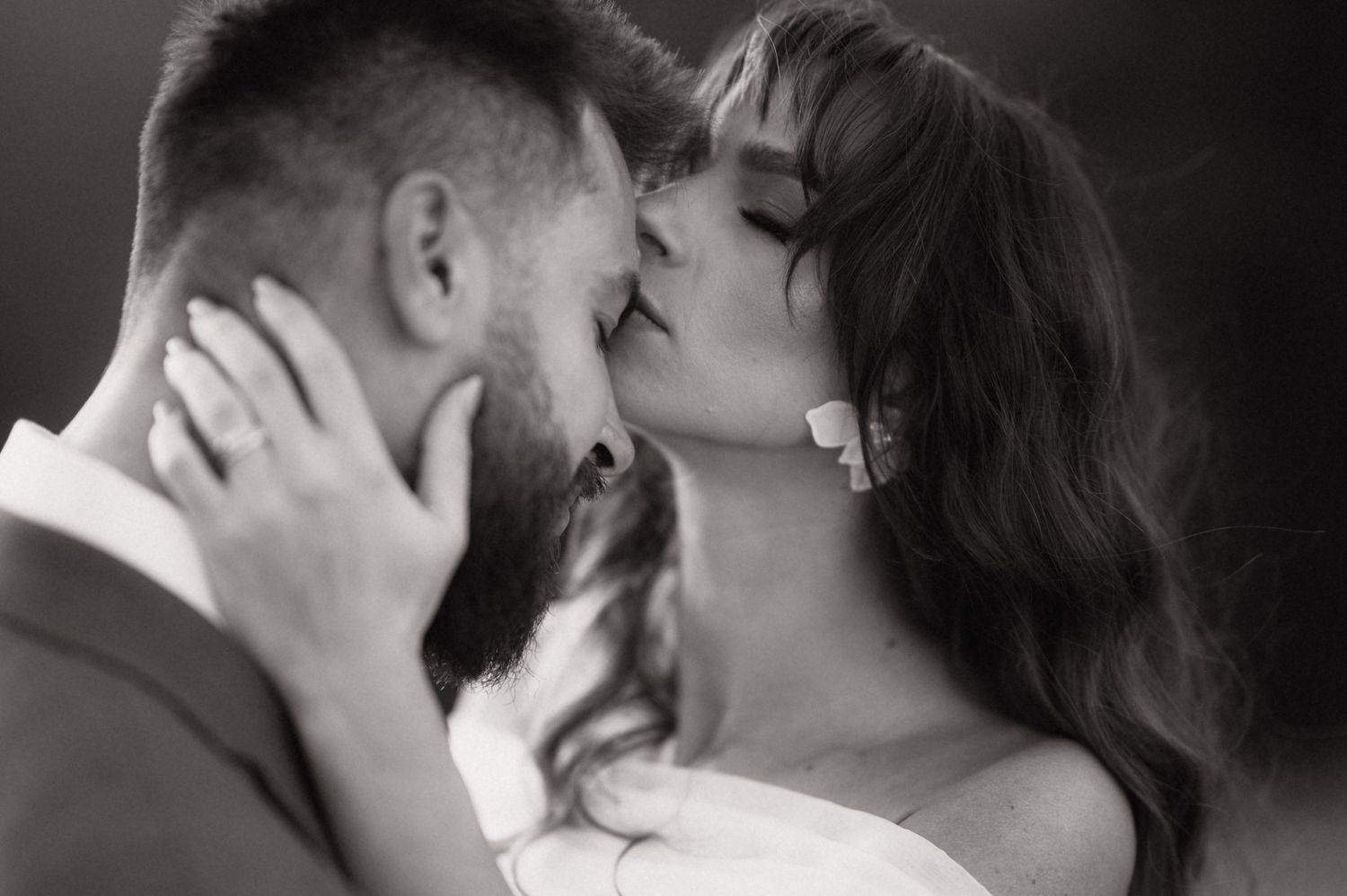 A black and white photo montage shows couples sharing intimate kisses in formal wedding attire.