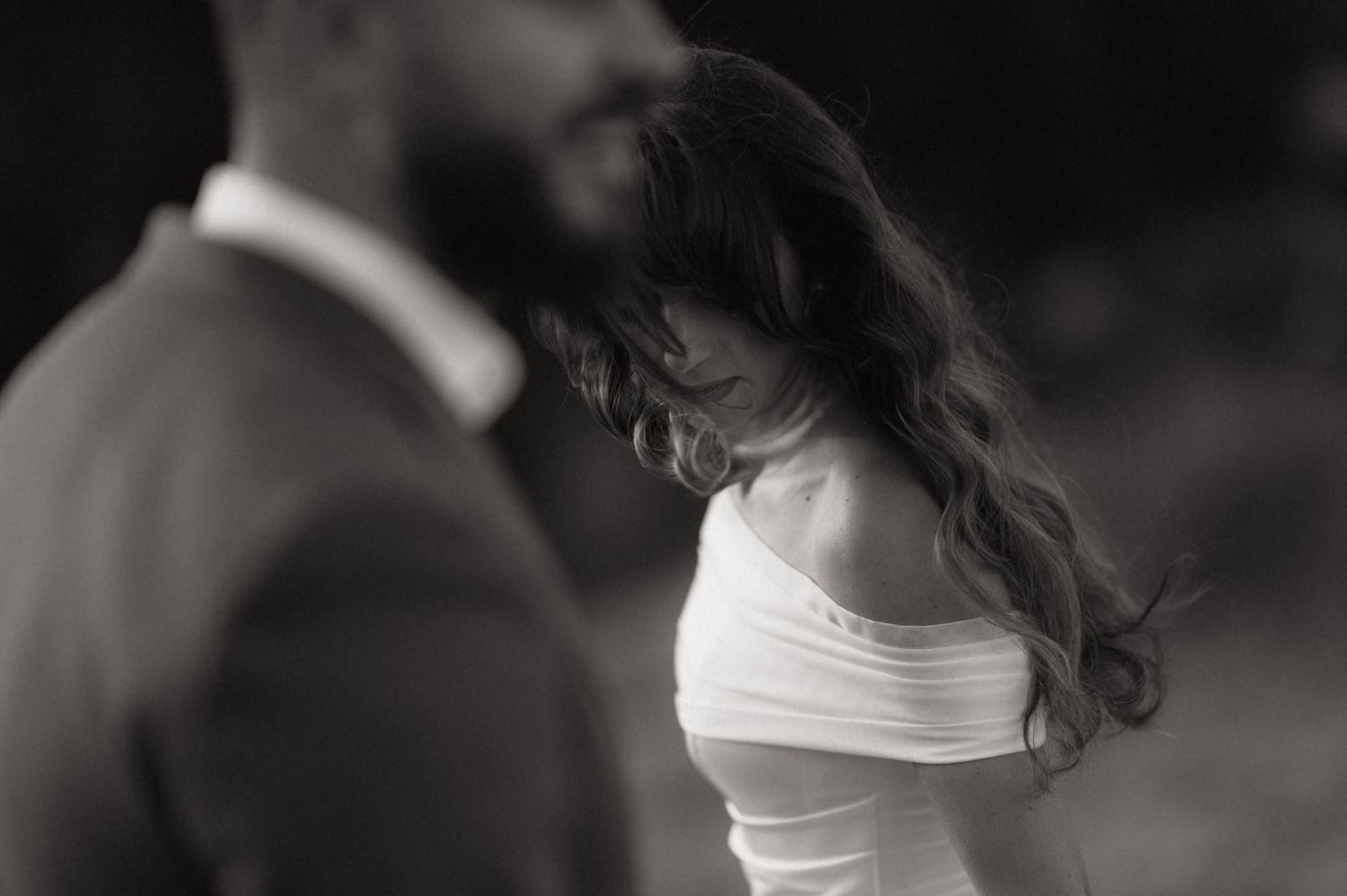 A black and white wedding photo montage shows intimate moments between a bride and groom during their special day.