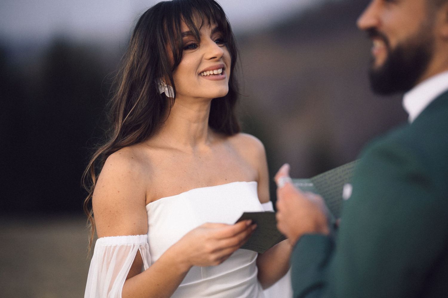 A bride and groom share intimate moments during their wedding photoshoot in an elegant outdoor setting.