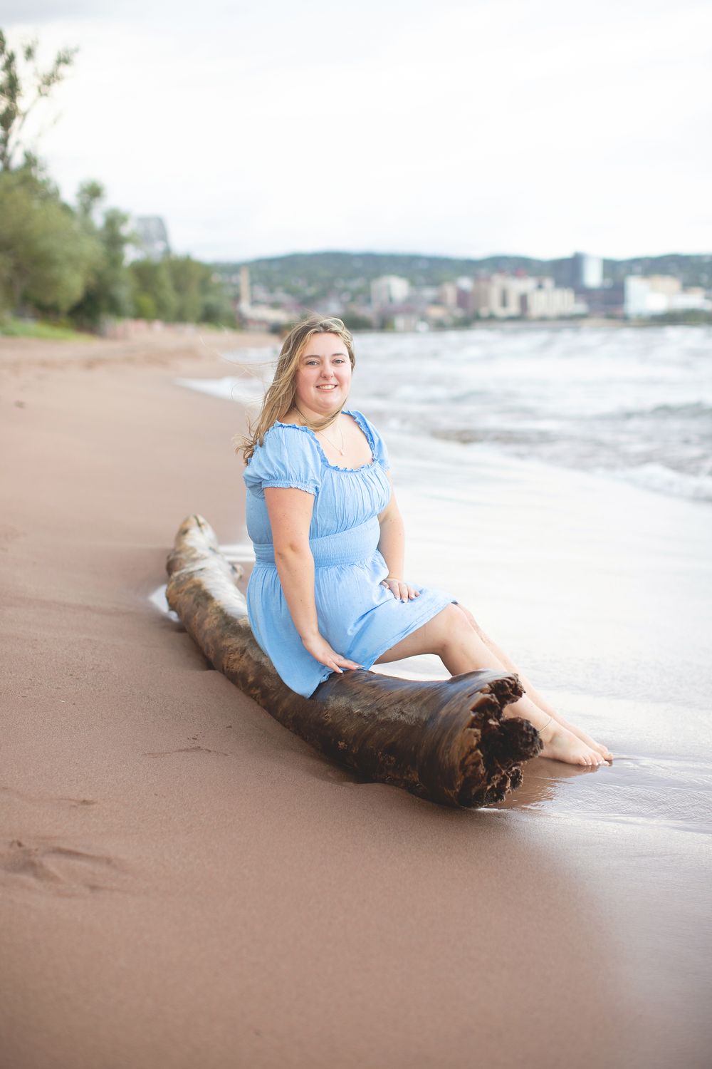 Senior photos on sandy beach at Park Point in Duluth, MN