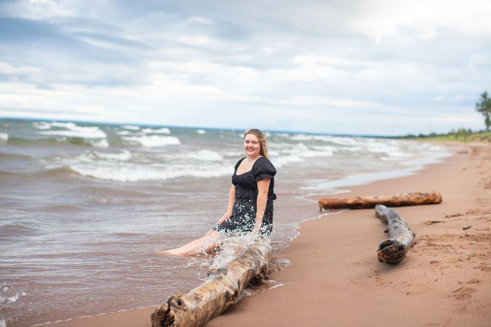 Senior photos on sandy beach at Park Point in Duluth, MN