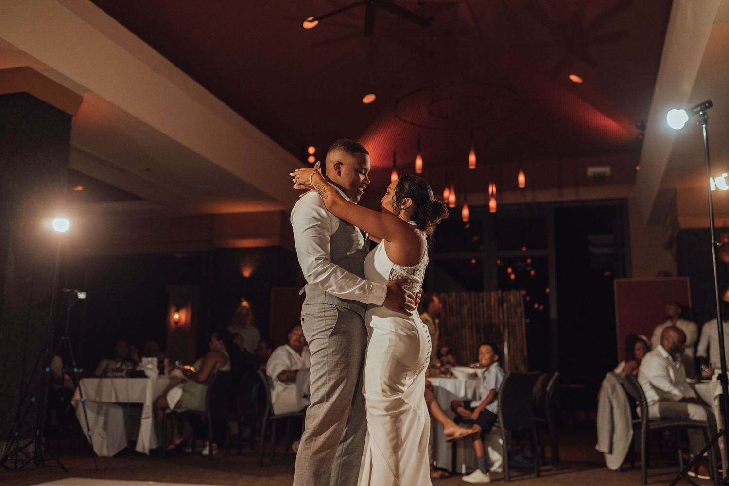 Guests dancing and celebrating at a lively indoor wedding reception.
