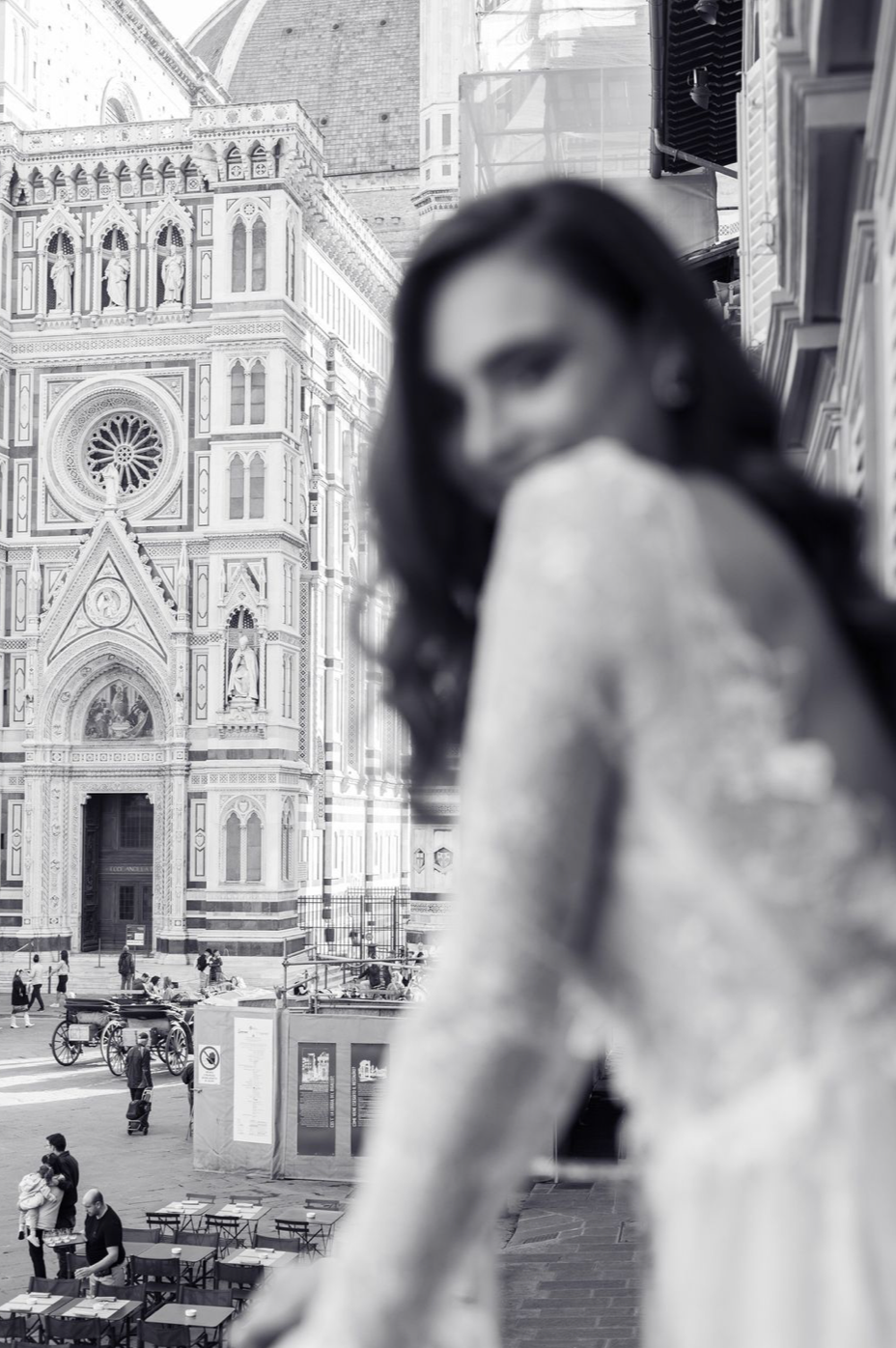 Vintage black and white photograph of Florence Cathedral and Piazza del Duomo with people in the background.