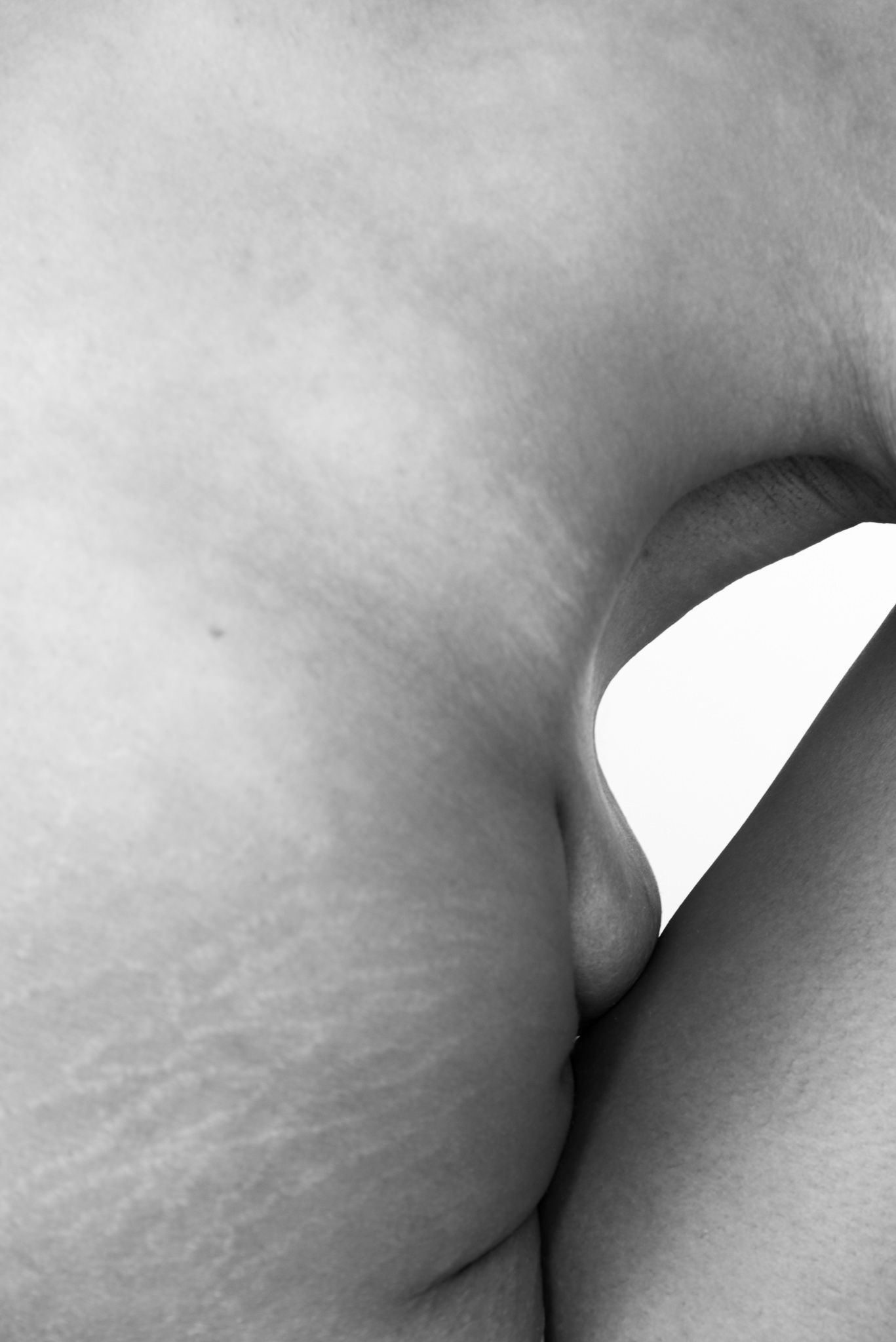 Abstract black and white photograph of smooth curved surfaces and shadows.