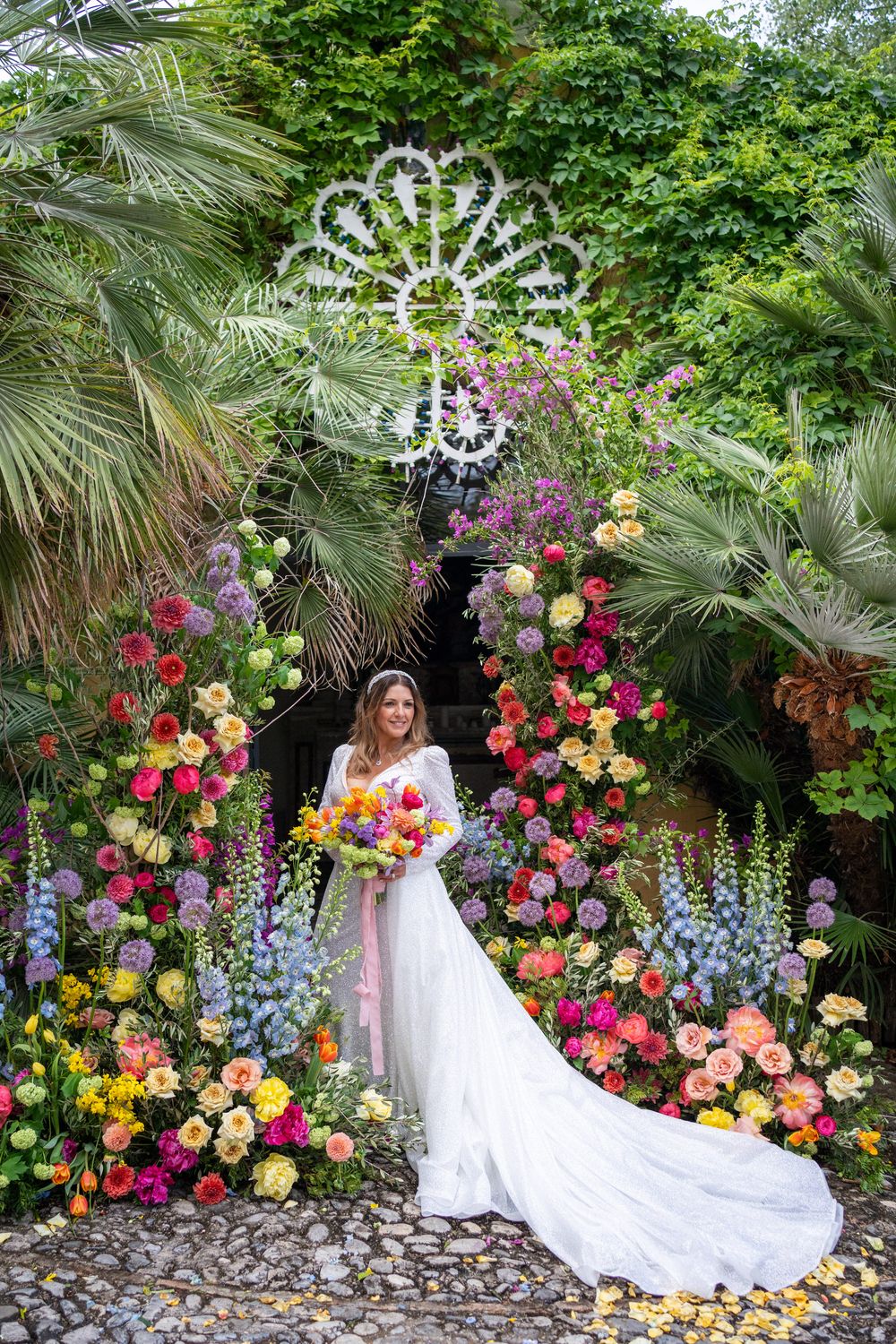 Luxury wedding in Calabria surrounded by colorful floral installation and Mediterranean garden