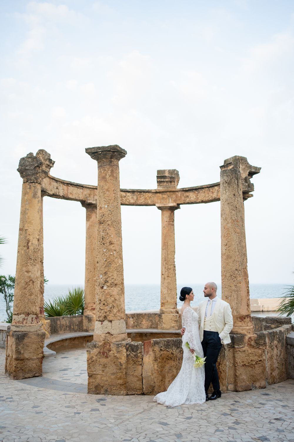 Bride and groom embracing in a Mediterranean garden in Calabria, destination wedding photography