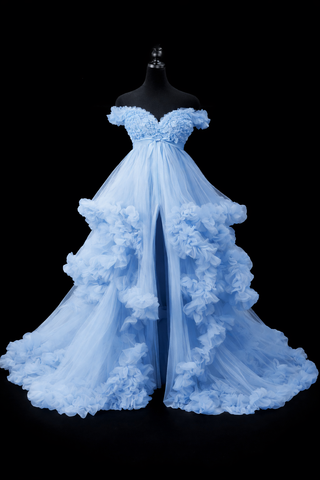 Light blue ruffled maternity gown with layered tulle and high slit worn by model.