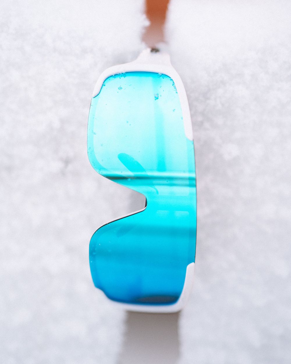 A series of close-up photos showing blue sea glass fragments arranged against a white textured background.