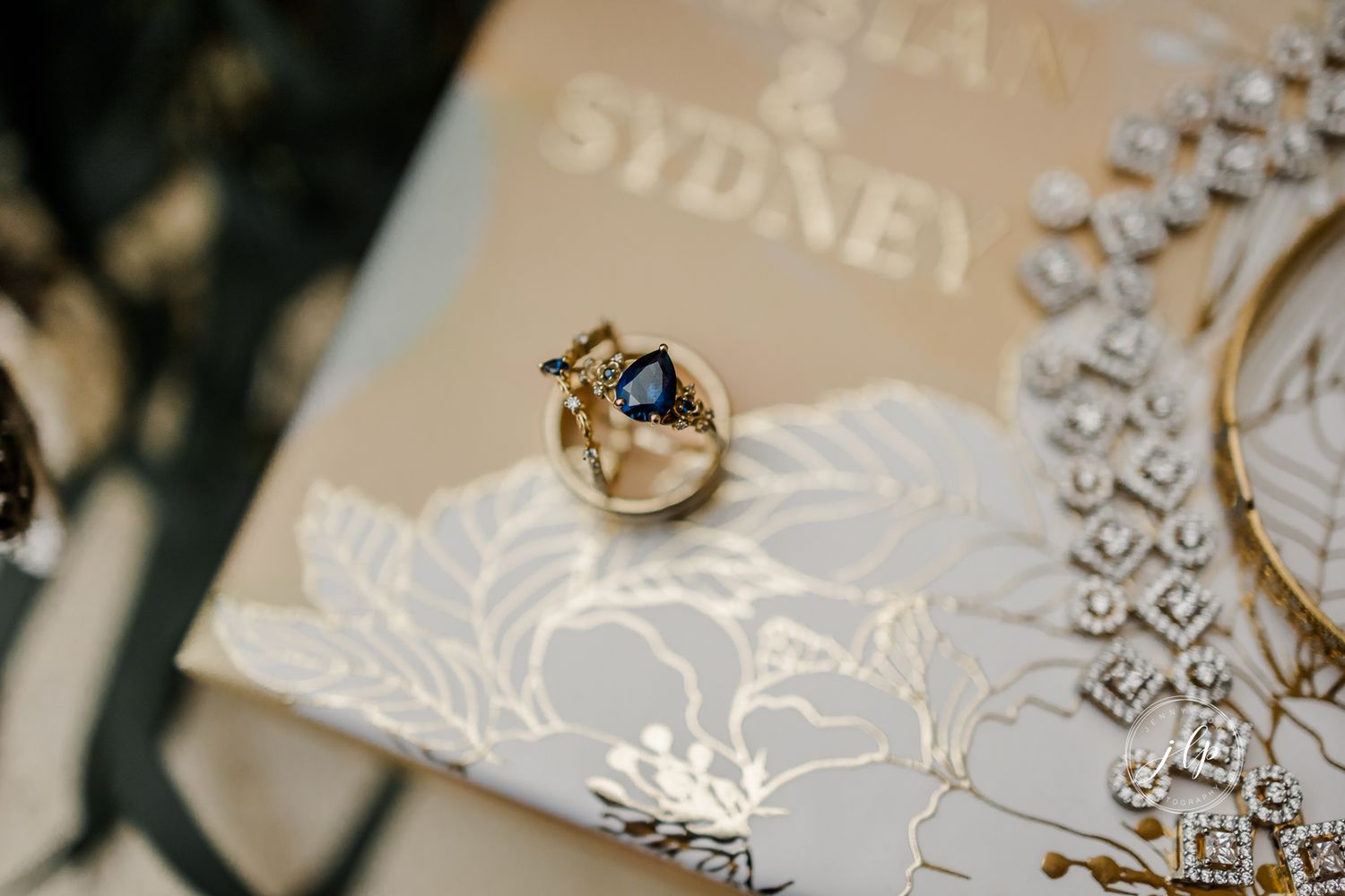 Elegant wedding stationery with embossed patterns and rings.