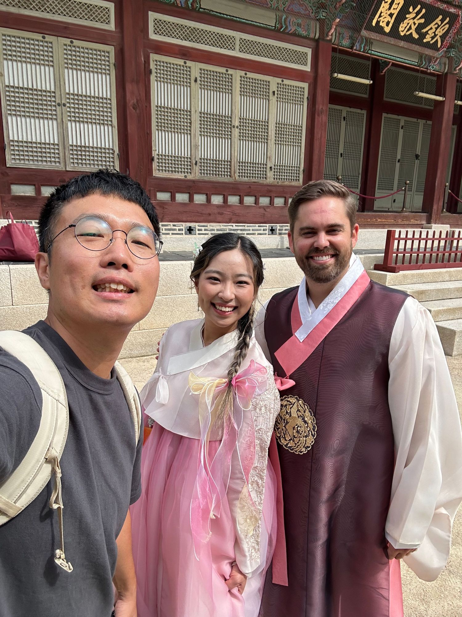 Traditional Korean costumes are worn by visitors enjoying a cultural experience at a historic palace.