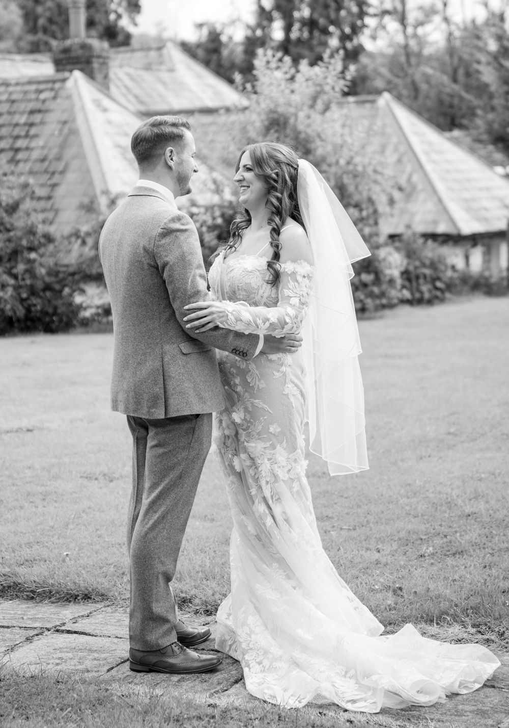 A romantic wedding couple embraces in the garden during their first look moment captured in a sequence of candid photos.