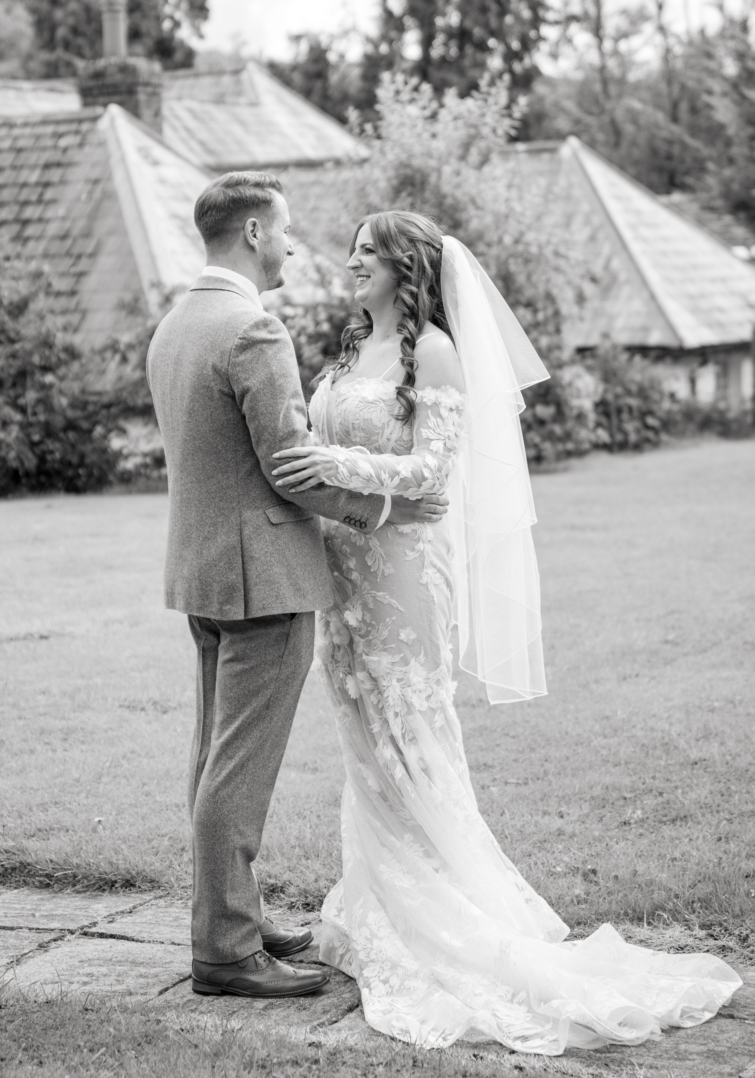 A romantic wedding couple embraces in the garden during their first look moment captured in a sequence of candid photos.