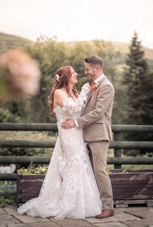 A romantic wedding photo sequence captured on a rustic deck with evergreen trees in the background at sunset.