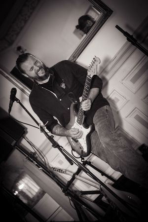 Black and white photos of a live band performing during wedding reception.