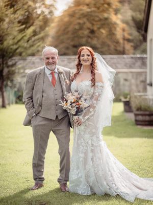 Wedding couple poses for romantic outdoor portraits in a lush garden setting with beautiful autumn colors.