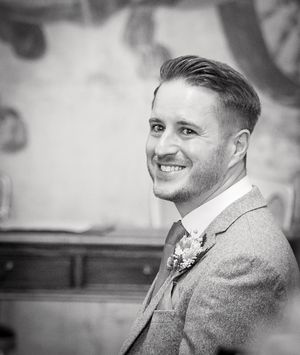 Black and white photo sequence showing changing expressions from profile view to candid smile in formal attire.