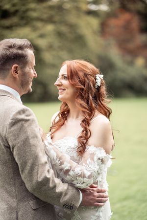 Romantic wedding portrait capturing couple in outdoor garden setting.