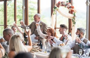 Wedding reception venue decorated with floral arrangements and warm lighting for an elegant celebration.