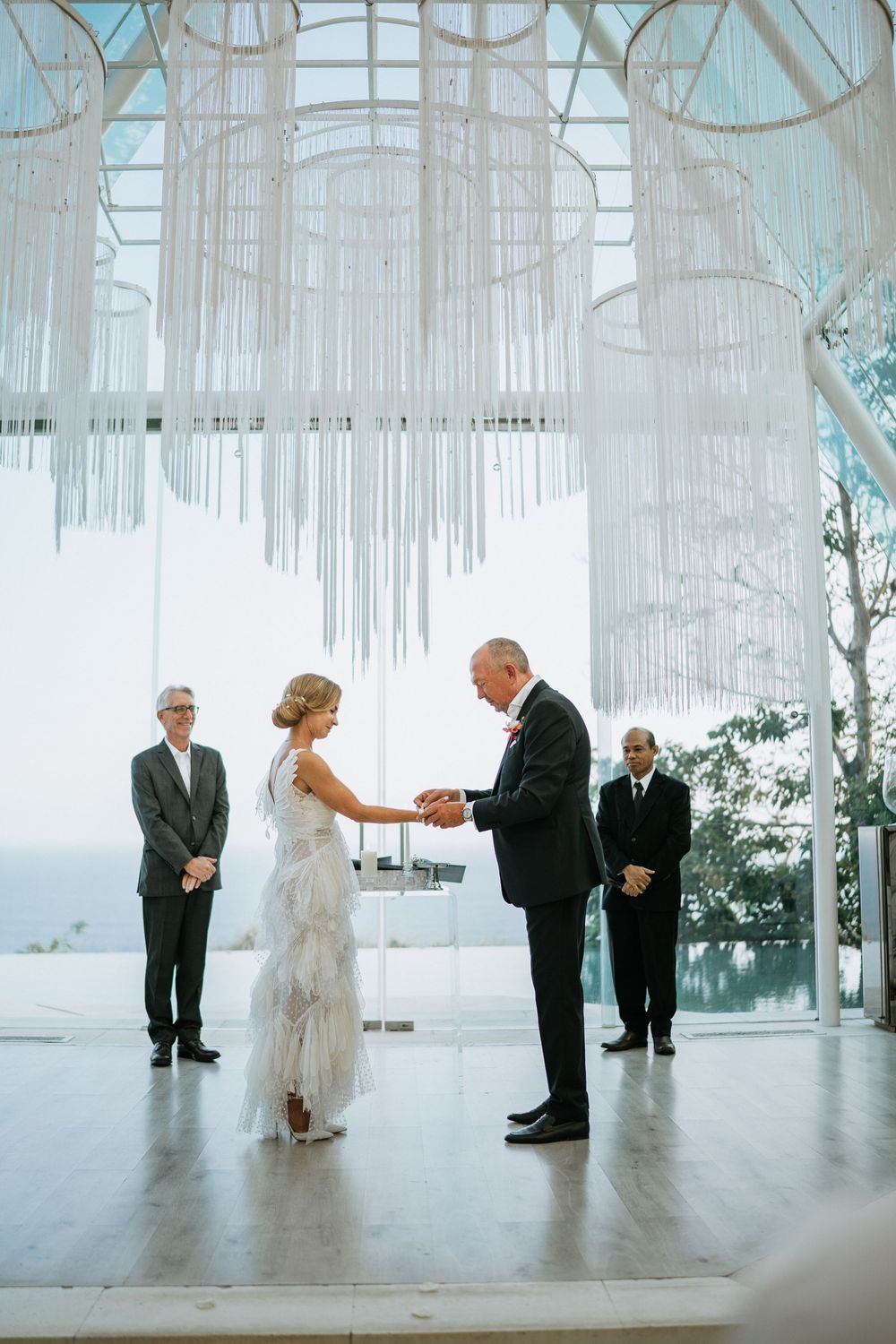 Wedding ceremony sequence showing couple exchanging vows in a modern white architectural space.