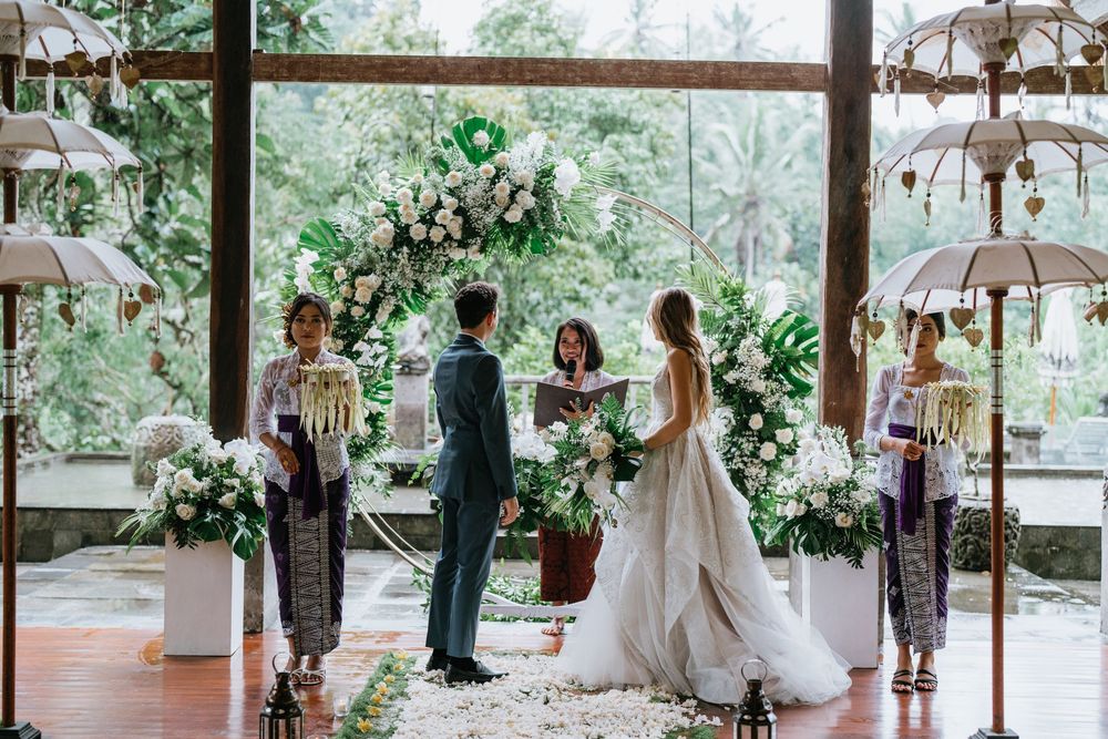 Wedding ceremony venue decorated with lanterns and floral arrangements in an indoor-outdoor setting.