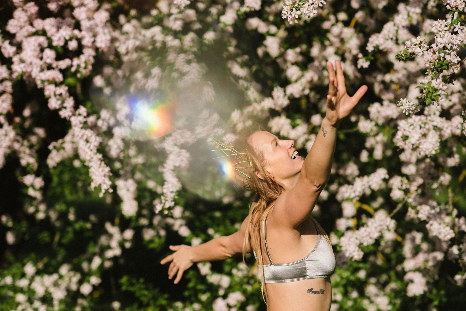 Dancing figure surrounded by delicate white cherry blossoms at night.
