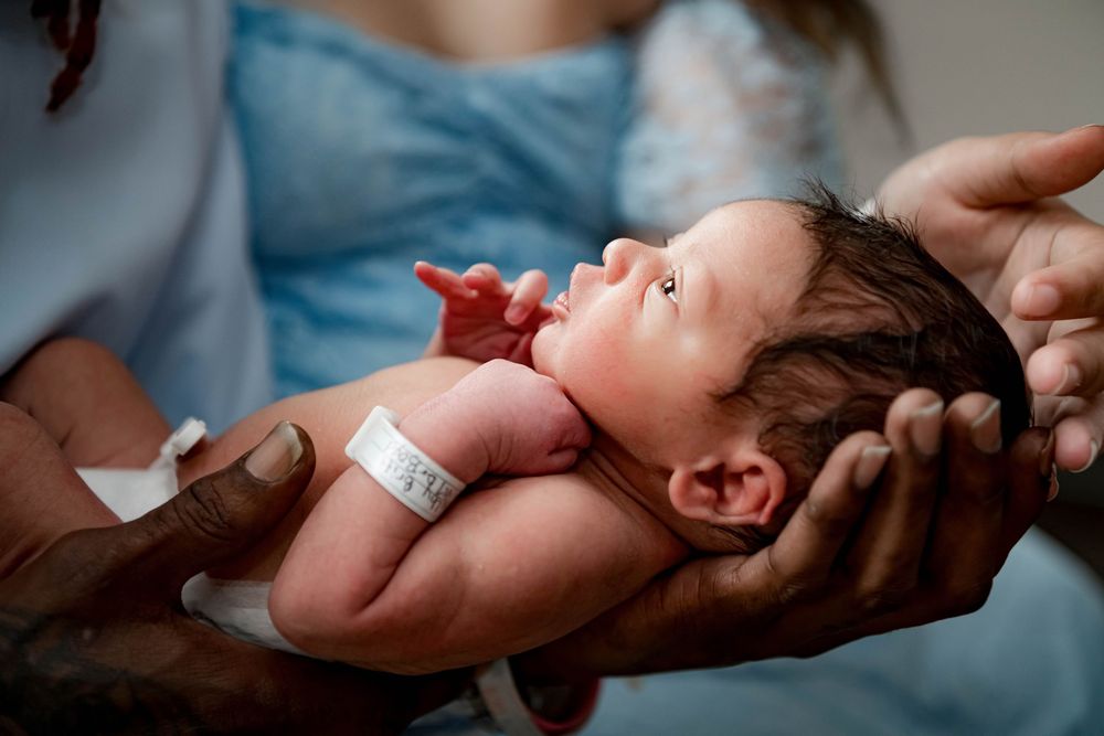 Hospital delivery room moments captured in documentary style.