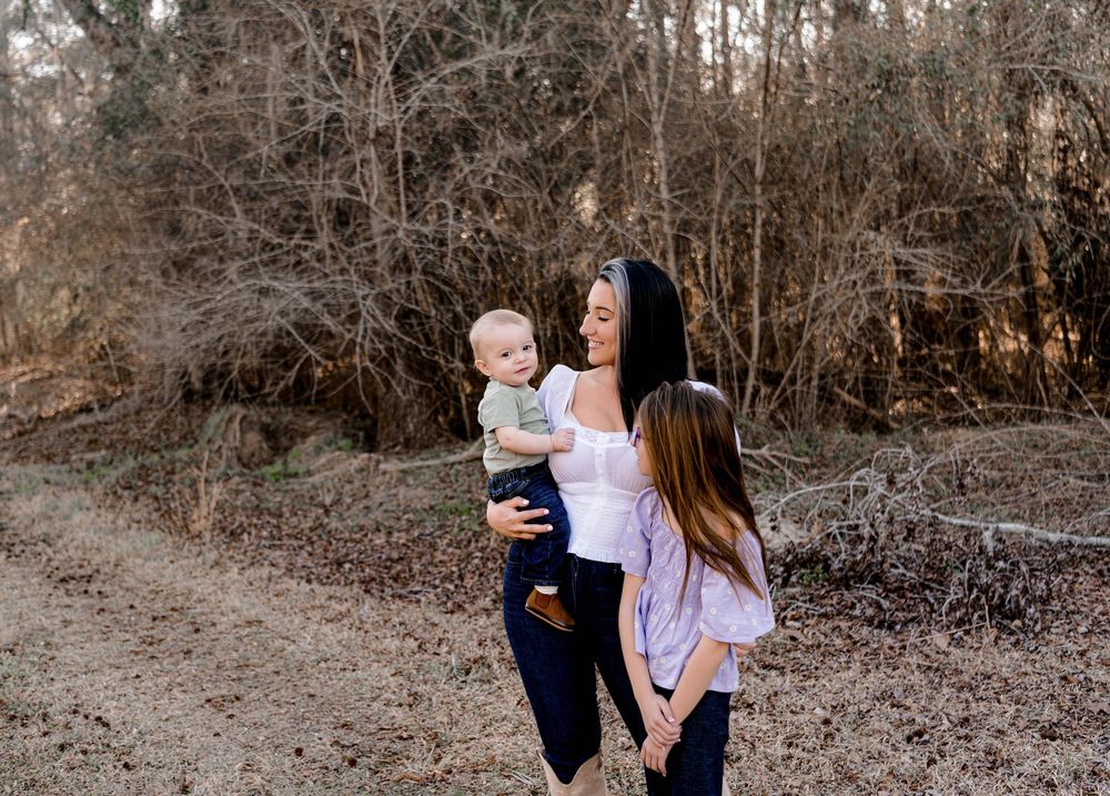 Family walking together on a wooded path during golden hour in Timmonsville, SC.