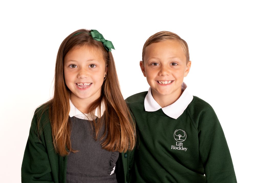 School portrait photography session showing students in green uniforms.