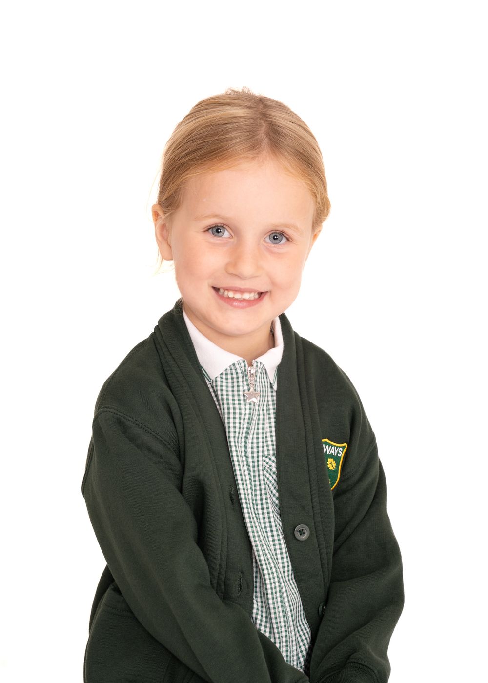 Students wearing green school uniforms and checkered shirts pose for individual portraits against a dark background.