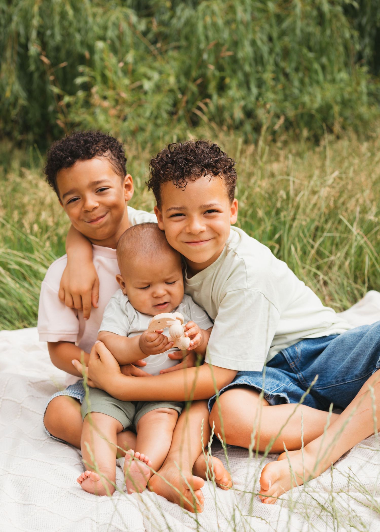 Family photography, brothers playing outside in summer by Sarah Shaw Photography, Hertfordshire