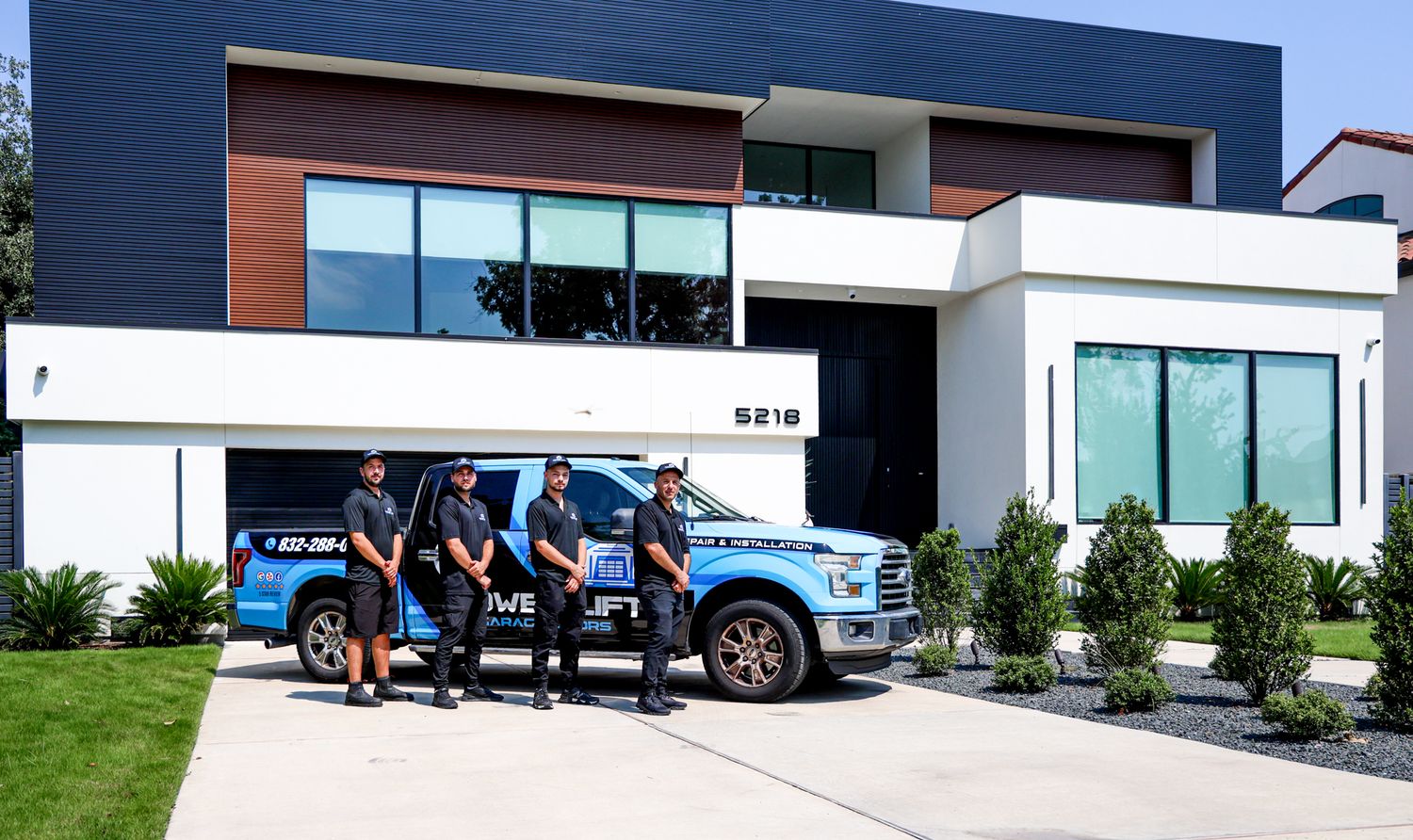 Modern commercial building exterior with blue metal roof and clean architectural lines.