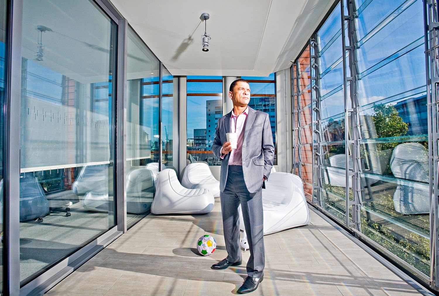 Personal branding portrait of business consultant Adrian Joseph in a modern London office